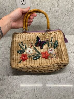 Woven Straw Handbag with Floral Embroidery and Bamboo Handles - Natural